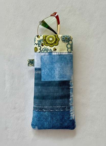 Handmade pouch with denim pattern and floral top section on a light gray background